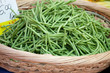Green string beans in woven basket close-up
