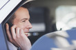 Politician talking on cell phone in backseat