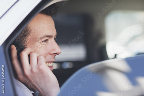 Photo: Politician talking on cell phone in backseat Politician talking on cell phone in backseat