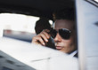Man wearing sunglasses in backseat of car