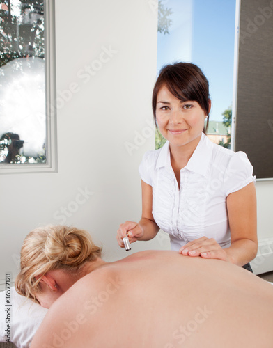 Photo: Acupuncturist Using Plum Blossom Tool Acupuncturist Using Plum Blossom Tool