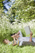 Father and son relaxing in grass