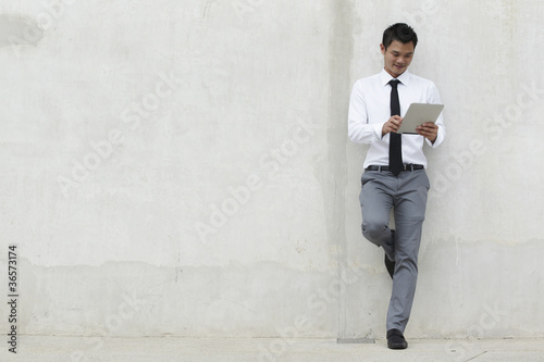 Photo: Asian Business man using a Digital Tablet Asian Business man using a Digital Tablet