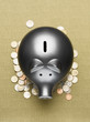 Piggy bank sitting on pile of coins
