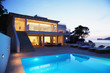 Pool outside modern house at twilight