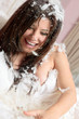 Happy woman among feathers
