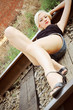 Photo: Beautiful young girl lying on rails Beautiful young girl lying on rails