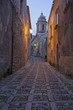 Cobbled alleyway of old city lit up at night