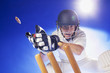 Cricket player lunging for bats