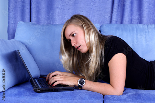 Photo: woman working with PC at home in sofa woman working with PC at home in sofa