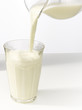 Pouring milk in a glass. Pouring milk in a glass.