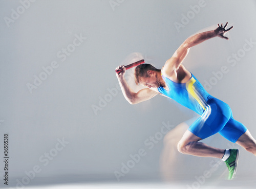 Photo: Blurred view of athlete running with baton Blurred view of athlete running with baton