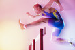 Blurred view of athlete jumping hurdles