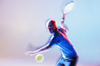 Tennis player swinging racket