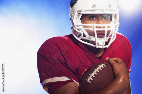 Photo: Football player carrying ball Football player carrying ball