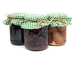 pickled pear,  plum jam and preserved cherries in glass jars