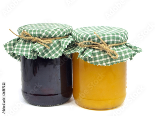 Photo: plum jam and honey in glass jars plum jam and honey in glass jars