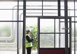 Businessman making notes in greenhouse