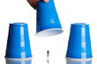 business figurines placed under plastic coffee cups
