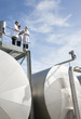 Scientists standing on walkway on tanks