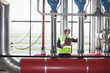 Photo: Businessman checking pipes in factory Businessman checking pipes in factory