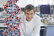Scientist with molecular model in lab