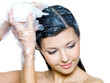 young woman dyeing hairs - isolated on white