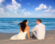 couple in love sitting in blue beach