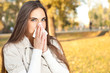 woman blowing her nose