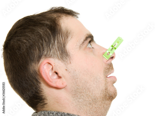 Photo: A patient man with a stuffy nose on a white background. A patient man with a stuffy nose on a white background.