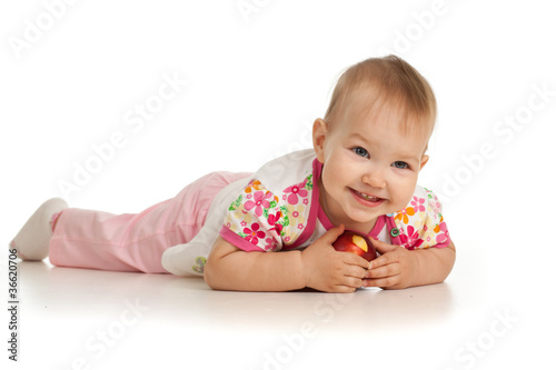 Photo: lying baby girl with red apple lying baby girl with red apple