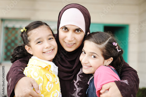 Photo: Muslim arabic mother with two daughters, love and care Muslim arabic mother with two daughters, love and care