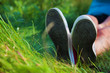 Pink sneakers on girl legs on grass Pink sneakers on girl legs on grass