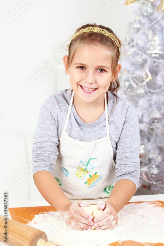 Photo: Cute girl baking cookies Cute girl baking cookies