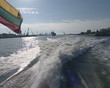 Small Lithuanian tricolor flag flying in wind at end of boat. Small Lithuanian tricolor flag flying in wind at end of boat.