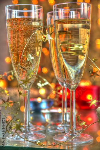 Photo: Close-up of champagne in glasses and candle lights. Close-up of champagne in glasses and candle lights.