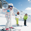 Skiing - happy skiers on ski slope Skiing - happy skiers on ski slope