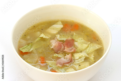 Photo: Vegetable cabbage soup in white bowl with bacon pieces Vegetable cabbage soup in white bowl with bacon pieces