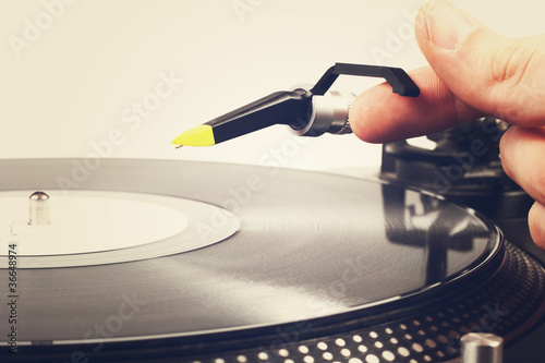 Photo: hand put the tonearm on vinyl record hand put the tonearm on vinyl record