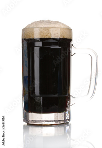 Photo: dark beer in a mug isolated on white dark beer in a mug isolated on white