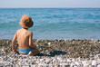 Little boy sitting on the seashore Little boy sitting on the seashore