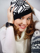 laughing girl in a knitted cap with the Norwegian pattern
