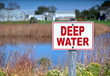 Sign warning of deep water.