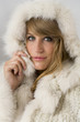 Portrait of attractive woman with real fur hood