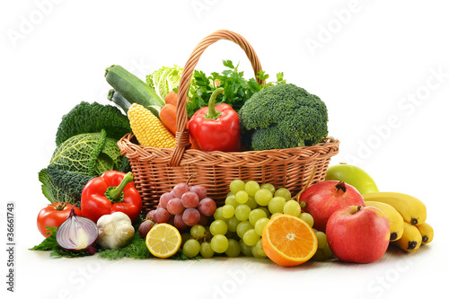 Photo: Composition with vegetables and fruits in wicker basket isolated Composition with vegetables and fruits in wicker basket isolated