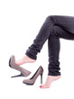 The woman sit and took off her shoes isolated