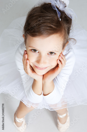 Photo: Beautiful little dancer, ballerina in white dress Beautiful little dancer, ballerina in white dress