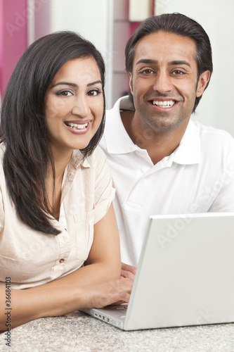 Photo: Asian Indian Man & Woman Couple Using Laptop Computer Asian Indian Man & Woman Couple Using Laptop Computer