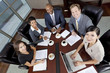 Interracial Men & Women Business Team Meeting in Boardroom