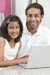 Asian Indian Father & Daughter Using Laptop Computer at Home